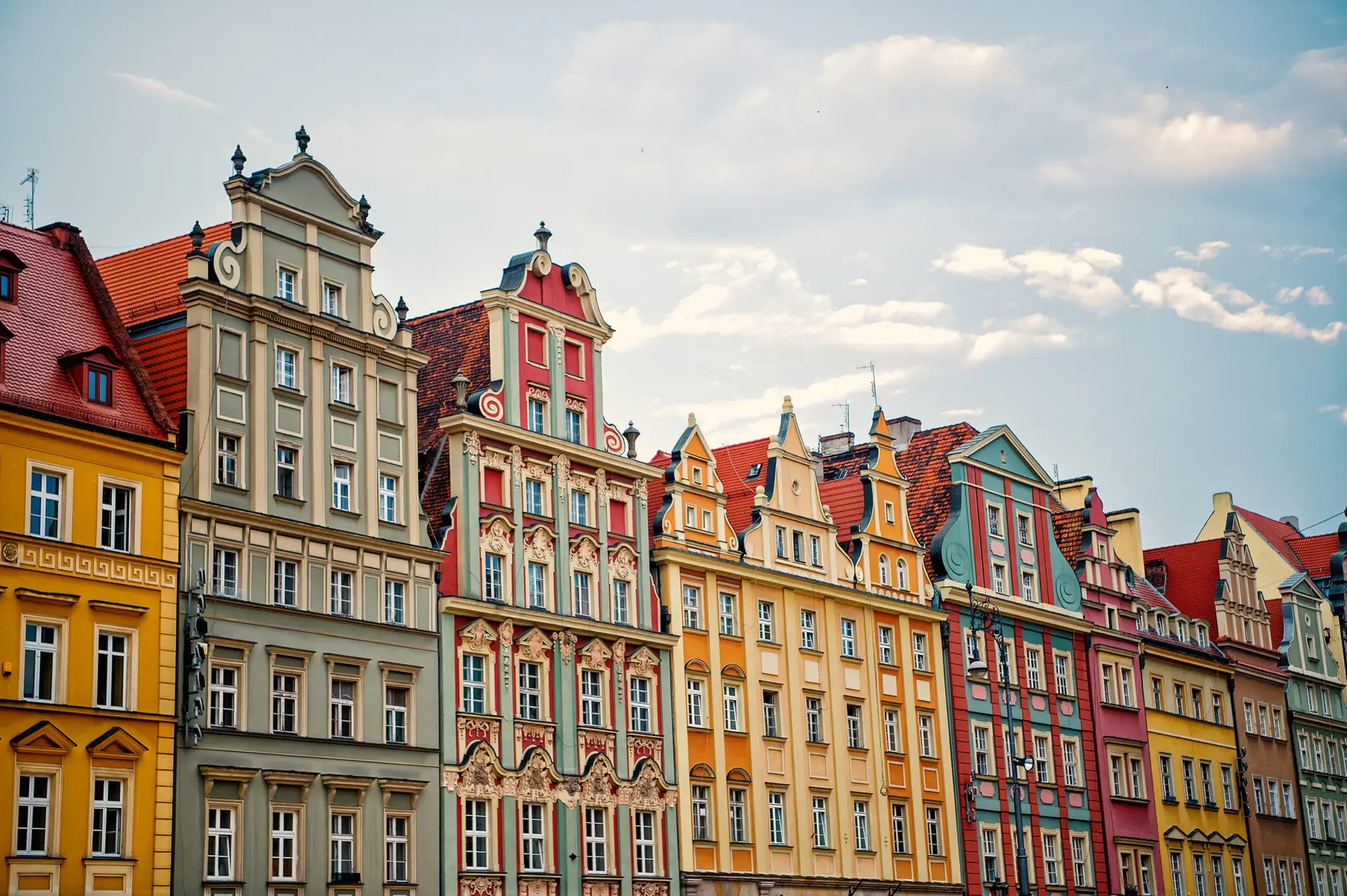 Houses with colorful facades on market square in wroclaw, poland on blue sky. Architecture, style, exterior, design concept. Landmark, attraction, sightseeing