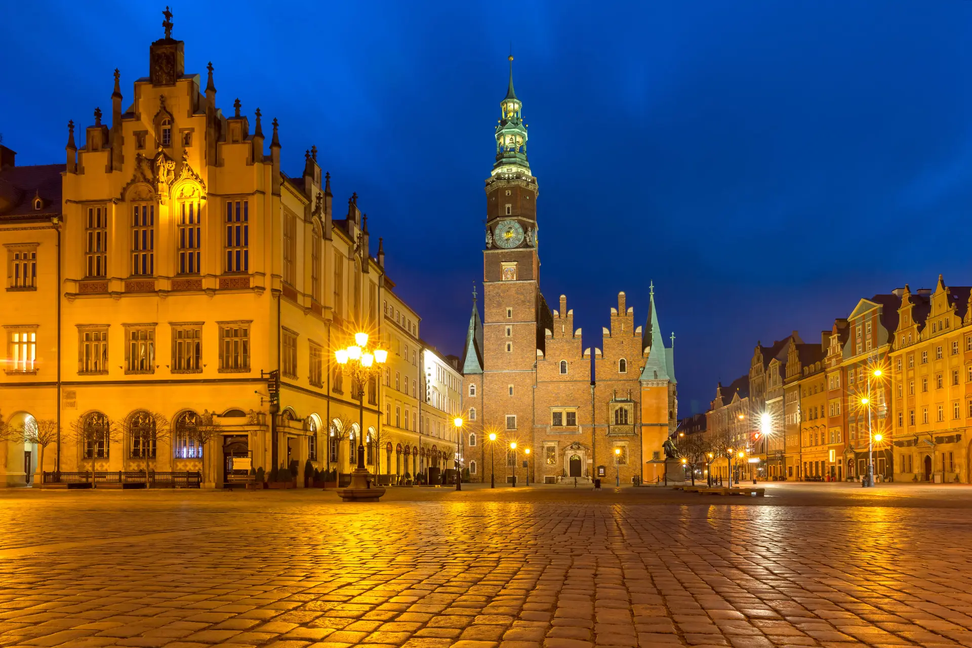 Oświetlony gotycki ratusz we Wrocławiu nocą – atrakcja tuż obok hostelu